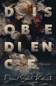 Cover of Disobedience by Daniel Sarah Karasik, featuring the letters of the title interspersed with illustrated white and pink flowers hovering over a dark ocean.