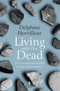 Cover of Living with Our Dead: The International Bestseller on Loss and Consolation by Delphine Horvilleur, featuring an illustration of many gray rocks on a light blue background.