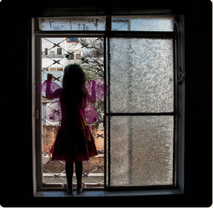 Cover image for Trace Fossils Review Spring 2024 issue, featuring a photo of a girl with butterfly wings on silhouetted against the window she looks out of.
