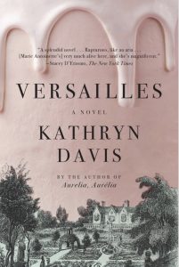 Cover of Versailles by Kathryn Davis, featuring a light green and black illustration of a mansion surrounded by a garden, with a light pink background that has icing dripping on the top. 